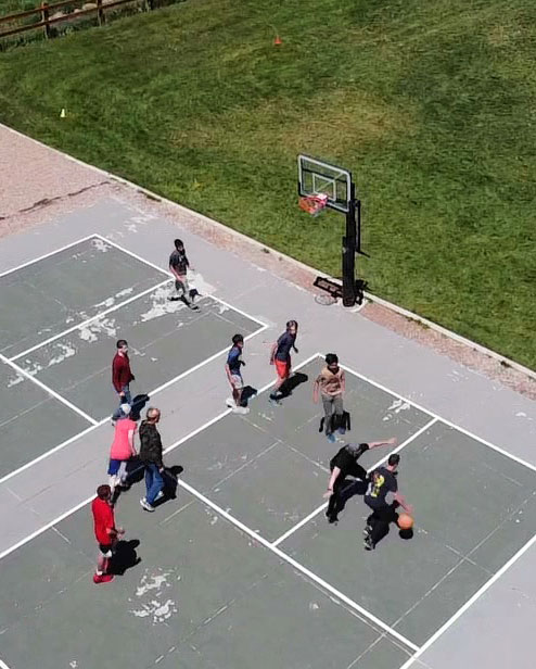 Teens playing basketball at a residential OCD treatment center for teenage boys and girls. | WayPoint Academy, a specialized anxiety treatment center for teens and their families.